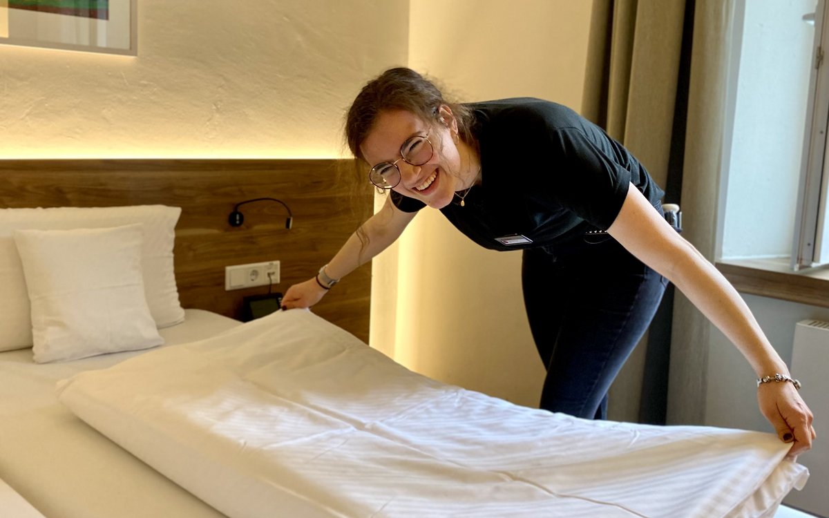 Eine Frau, die das Bett macht 